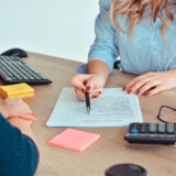 kobieta wskazująca na zapis w umowie